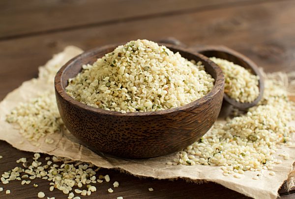 Uncooked Hemp seeds in a bowl with a spoon