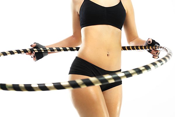 flat stomach and firm buttocks,the woman trains with wheel hula hop.