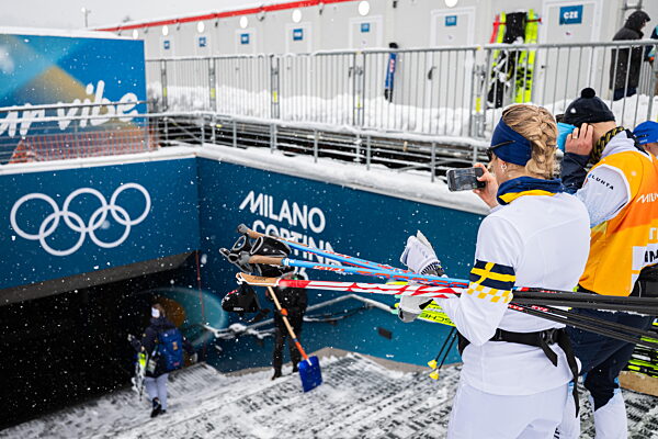 260203 Frida Karlsson of Sweden takes a photo of Moa Ilar as she pass the...