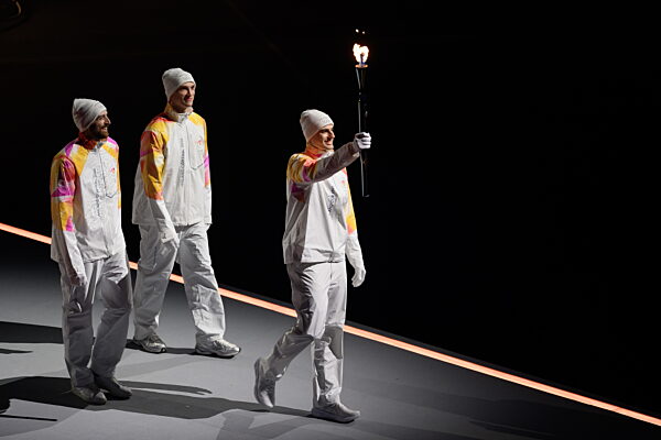 260206 The Olympic torch is carried  during the Opening Ceremony of the 2026...