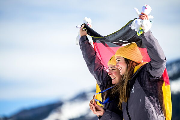 260218 Laura Gimmler of Germany and Coletta Rydzek of Germany celebrate...