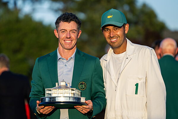 260412 Rory McIlroy of Northern Ireland pose with caddie Harry Diamond and...