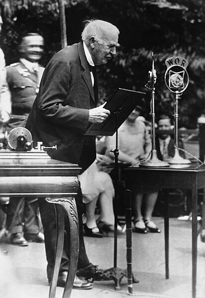 Thomas Alva Edison speaks into a microphone, 1927