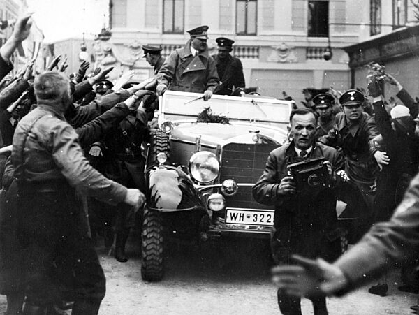 Adolf Hitler drives through Ried in Austria, 1938