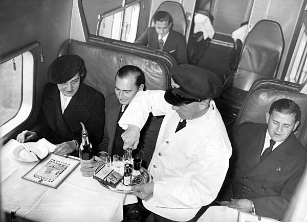 Steward serves passengers on board a Junkers G-38, 1937
