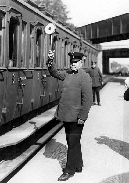 Railway employee gives the permission to departure signal, 1930