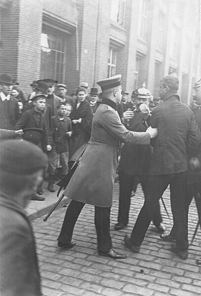 Police arrest a rioter during a strike. 1910
