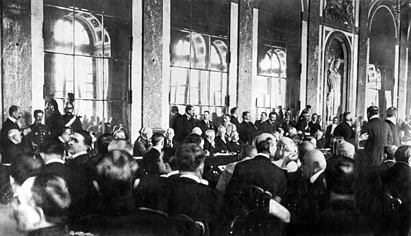 Woodrow Wilson and Georges Clemenceau signing the Treaty of Versailles, 1919