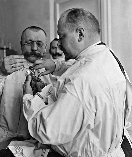 Veterinary treatment on a parrot, 1908