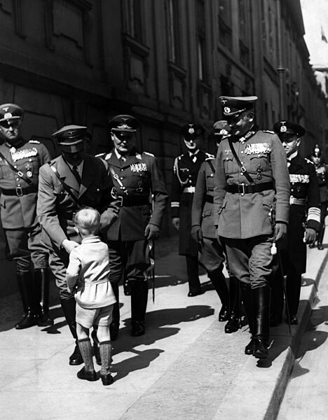 Adolf Hitler with a young well-wisher, 1935