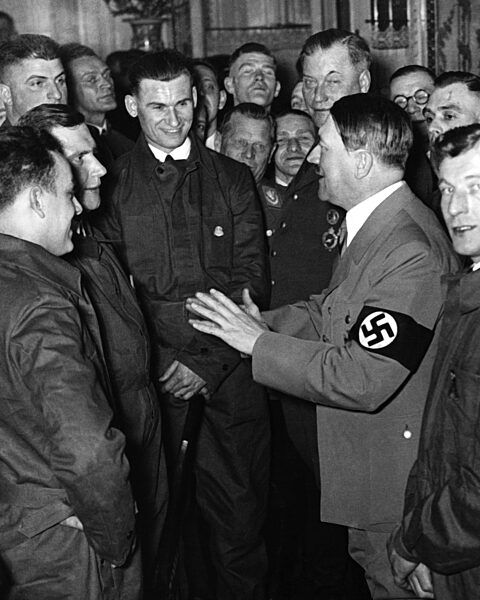 Adolf Hitler greets mechanics, 1936