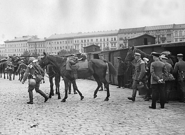 Soldiers lead their horses out of wagons