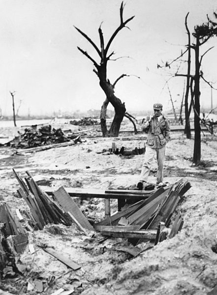 Hit By The Atom Bomb. Allied correspondent looks down on the remains of a...
