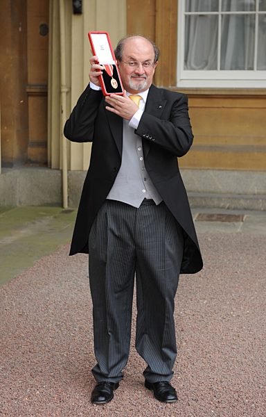Author Sir Salman Rushdie smiles after receiving his Knighthood from Queen...