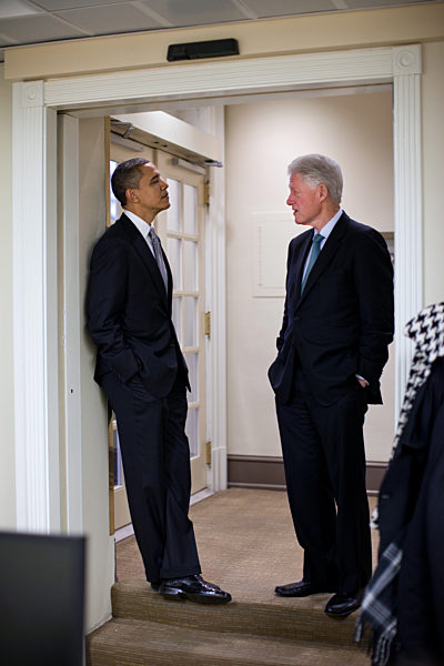 President Barack Obama talks with former..........