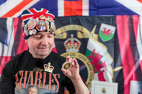 Royal Super fan, John Loughrey, with some of his King Charles souvenirs. London, UK