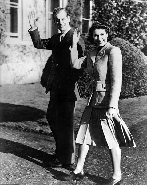 Princess Elizabeth and the Duke of Edinburgh waving to the cameras while...