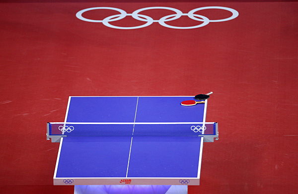 Two rackets lie on the table during the womens team table tennis preliminary...