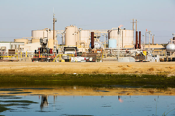 A fracking site being fracked near Wasco in California's Central Valley, USA. Fracking for natural gas and oil, has reduced energy prices in the US, but fracking is a water hungry industry, that competes directly with the agricultural sector for water. Aft