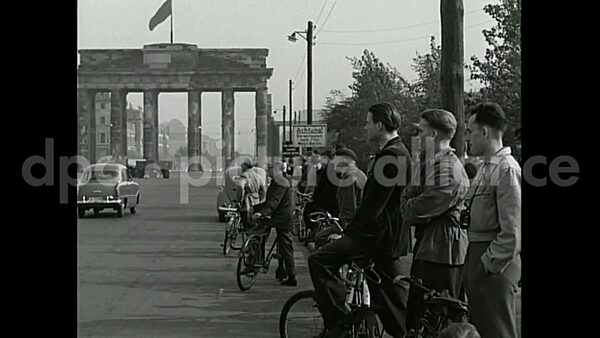 November 22, 1954 – Berlin Germany: German policemen and a USAF airman watch as explosives bring down the Reichstag dome in Tiergarten, Berlin.