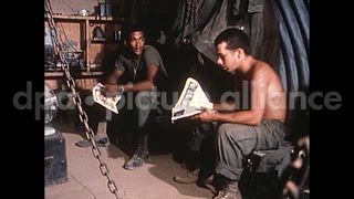 June 4, 1970 – Vietnam: Two soldiers read magazines inside a dual blade bunker at Camp Carroll in Vietnam.