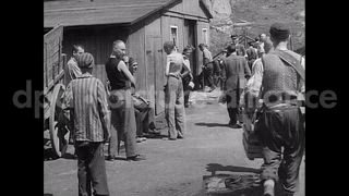 May 11, 1945 – Mauthausen Austria: Piles of dead bodies and survivor men and women at a Nazi concentration camp in Mauthausen, Austria after liberation (WW2)