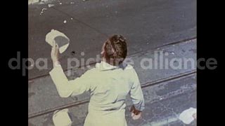 August 15, 1945 – Honolulu Hawaii USA: People celebrate VJ Day as a boy sells newspapers carrying news bout the end of World War II.
