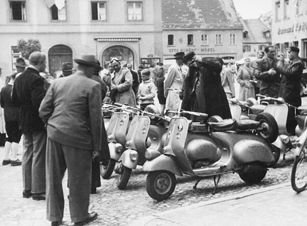 Passanten begutachten Vespas