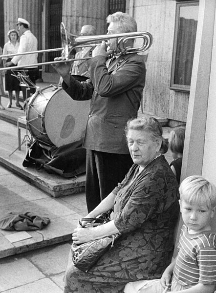 Alte Frau und Kind mit Straßenmusikern