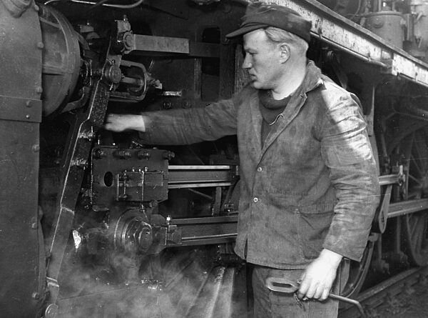 Maintenance work on a steam locomotive, 1950