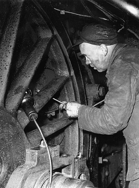 Maintenance work on a steam locomotive, 1950