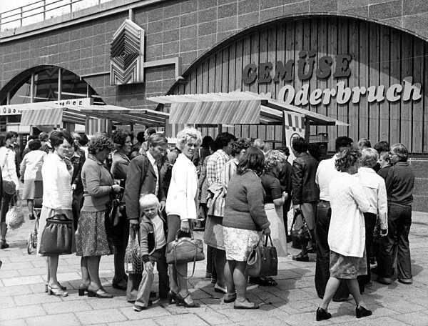Buyers queue in front of a vegetable stall in East Berlin, 1978
