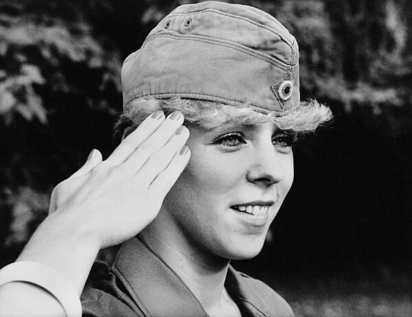 Woman applies make-up in the mirror