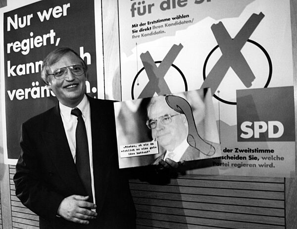 SPD Federal Executive Peter Verheugen with poster, 1994