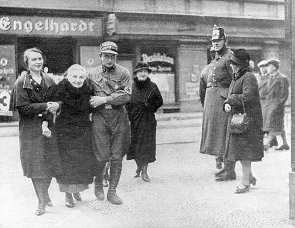 National Socialists escort an old woman to the election, 1932
