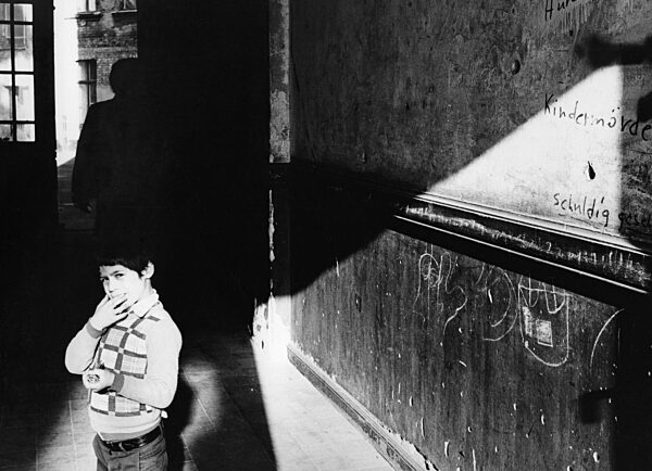 Child in a house entrance in Berlin-Wedding, 1978
