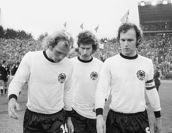 The 1974 FIFA World Cup: GDR - Germany 1-0 in Hamburg. From left: Uli Hoeness, Paul Breitner, Franz Beckenbauer disappointed