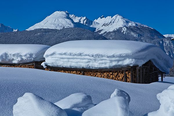 Austria, Europe, Tyrol, Mieminger plateau, Obsteig, Holzleiten, winter, snow, wooden pile, firewood, wood, forest, mountains, Lechtal, Lech valley, Alps, Heiterwand, sky, vacation, winter vacation, winter, traveling, calendar picture, nature, rest,