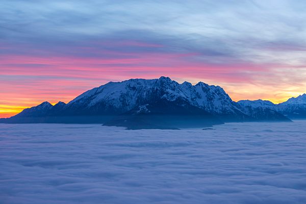 Sea of fog and snow-capped mountain in sunset with colorful sky in ticino Switzerland, Europe,