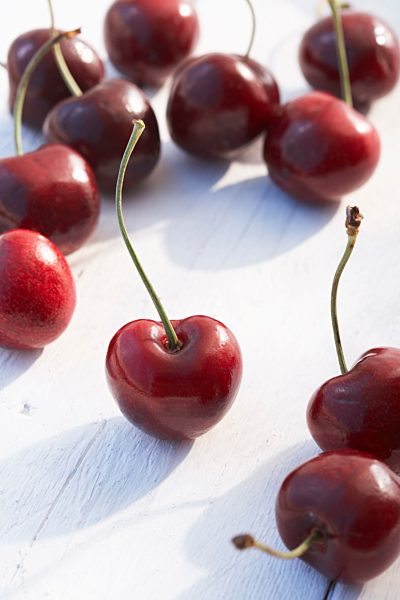 Redcherries scattered on a table