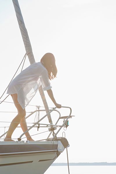 Girl climbing on front of boat