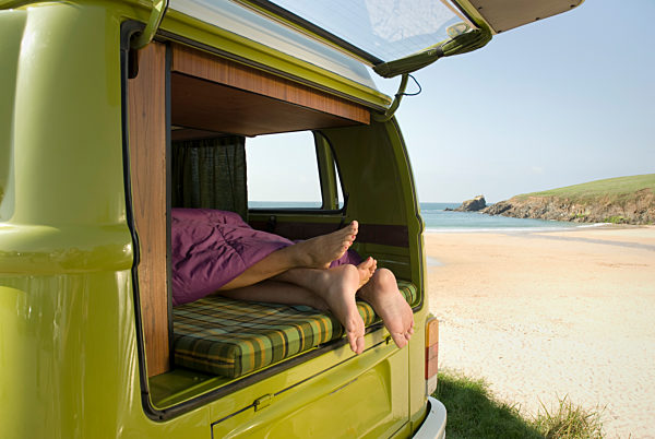 Couple lying in camper van
