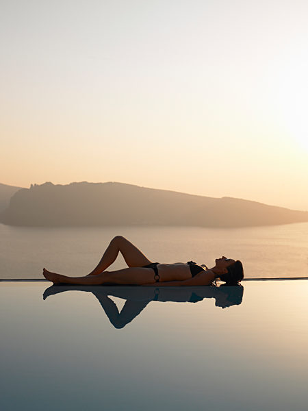 Woman laying on the edge of a pool
