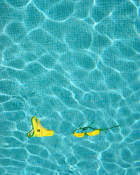 Bikini floating in empty pool.