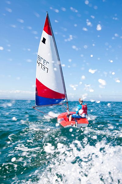 Teenager sailing boat