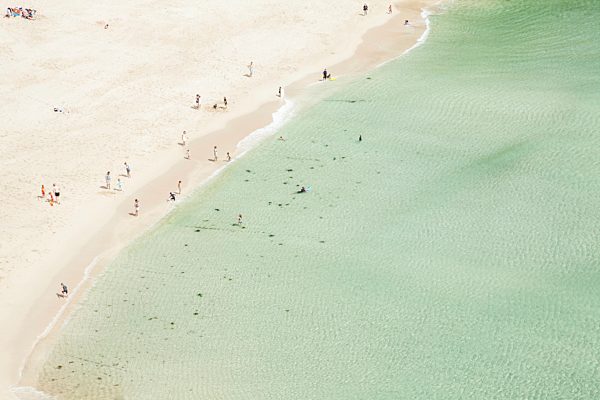Aerial view of holiday makers on beach, Porthcurno, Cornwall, UK