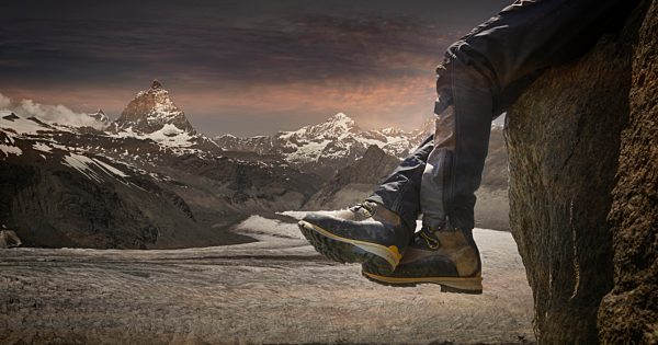 Legs of male climber dangling over rock edge, Zermatt, Matterhorn, Canton Wallis, Switzerland