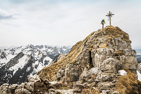 Young male hiker on peak of Klammspitze mountain, Oberammergau, Bavaria, Germany
