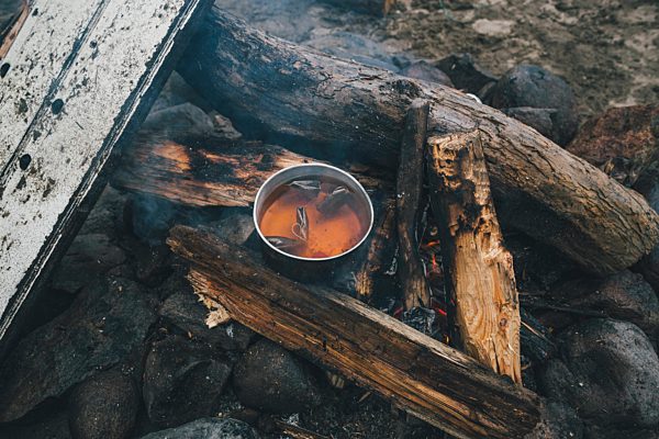 Norway, Lofoten, Moskenesoy, Food cooking on camp fire