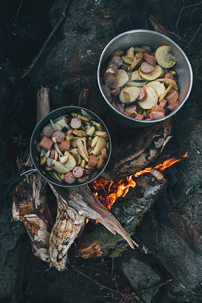 Norway, Lofoten, Moskenesoy, Food cooking on camp fire